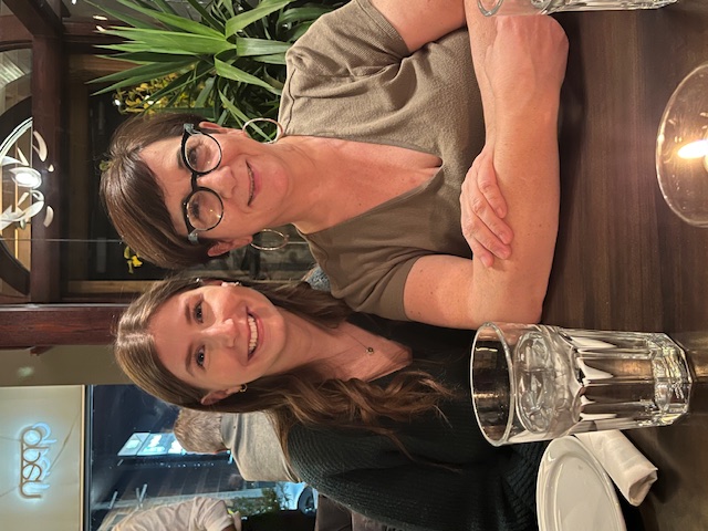 Tamar Barr seated with a community member
